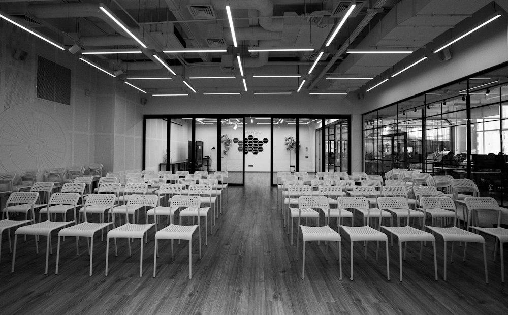 Empty hall with rows of chairs where sound echoes